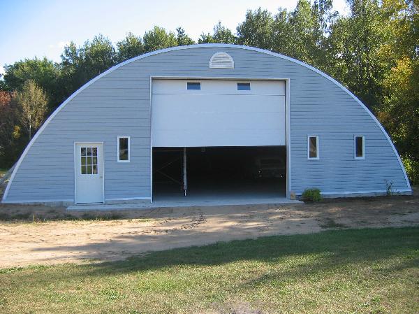Arch building with custom siding used on front endwall