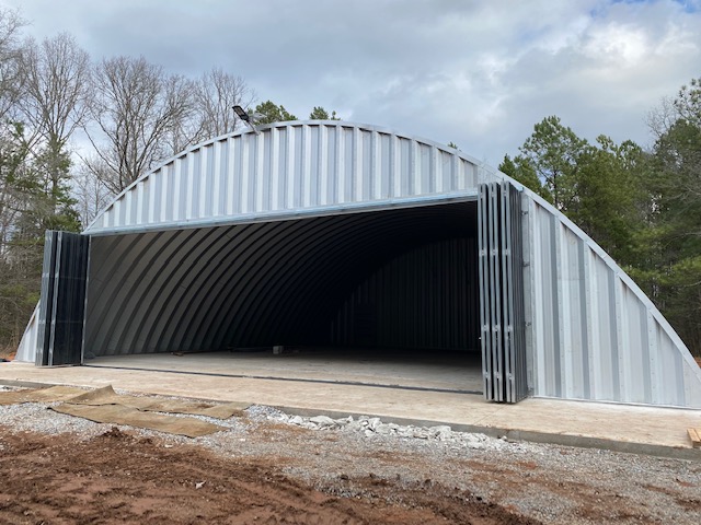 Arch recreation storage building with steel accordian doors