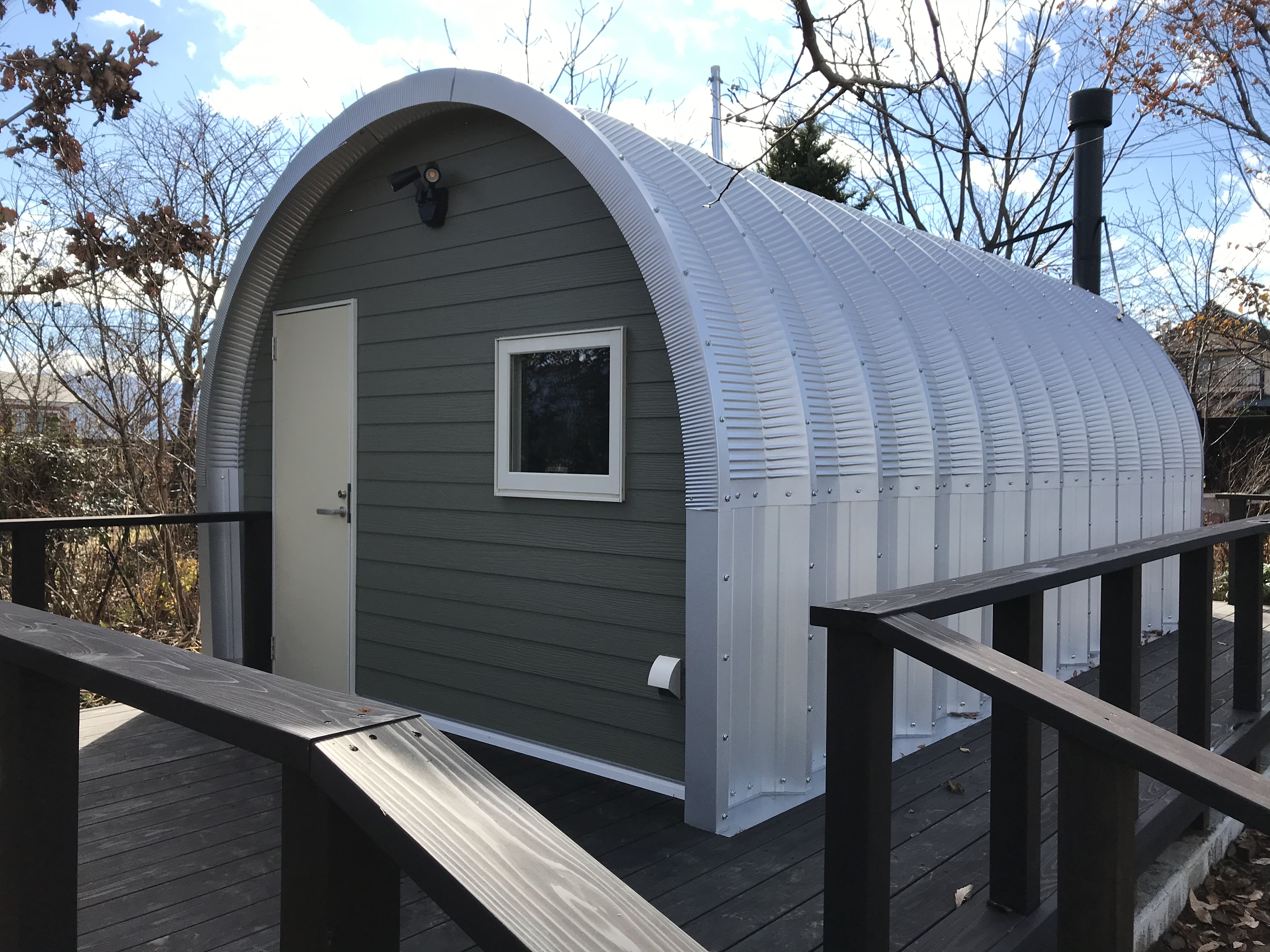 S-Series tiny house exterior with custom green front wall