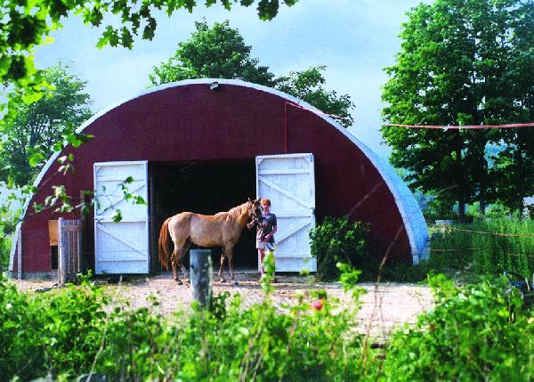 Arch horse barn with custom red endwall