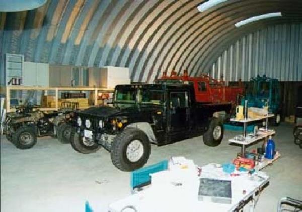 Arch building large garage with hummer